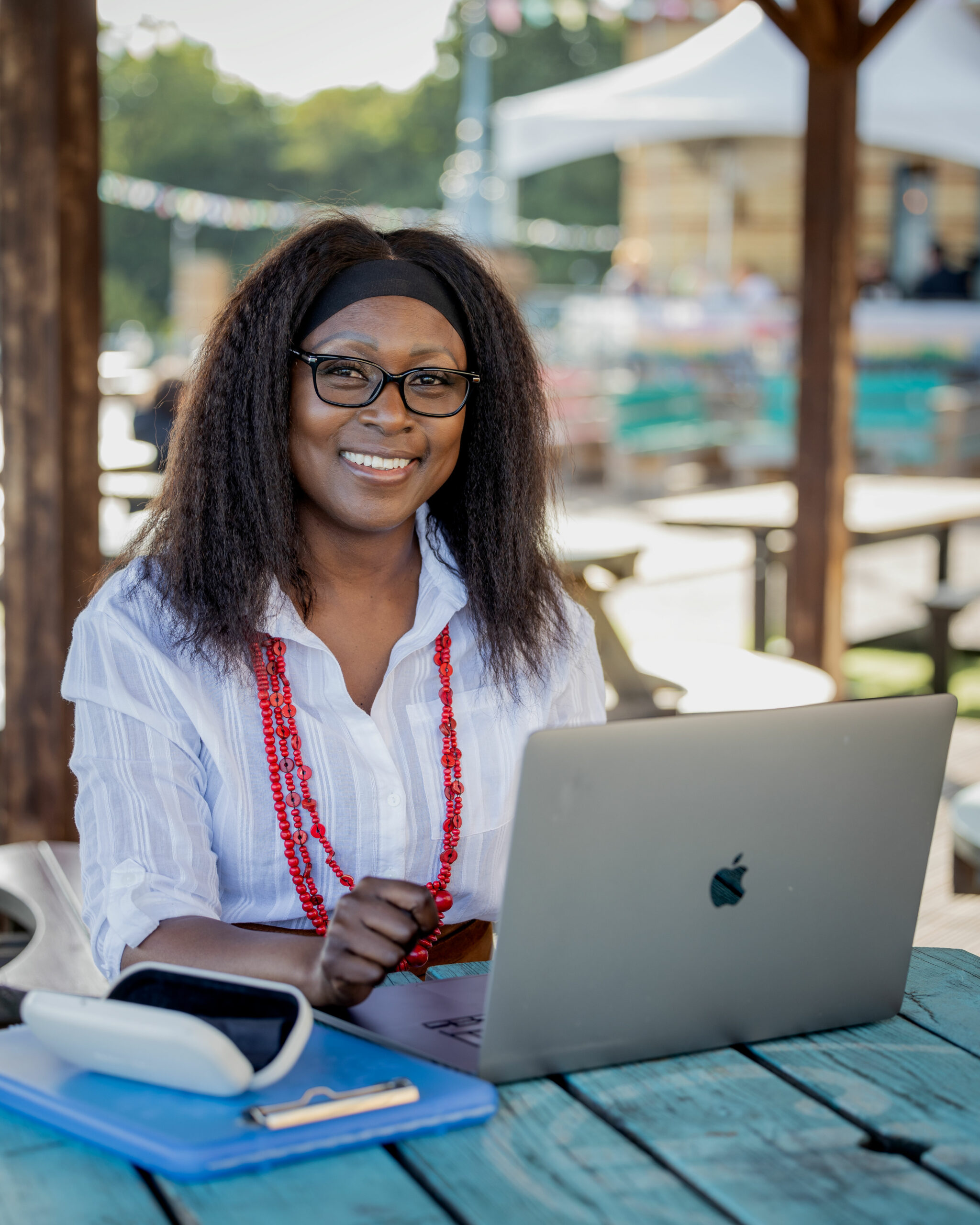 Patrice L. Williams seated at a table with her laptop